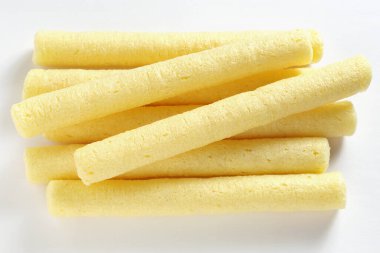 Corn crispy sticks or flip snacks on a white background close-up