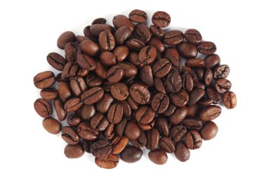 Close up of roasted coffee beans on white background, top view