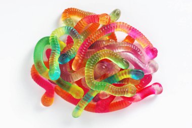 Heap of bright colorful jelly worms on white background, top view