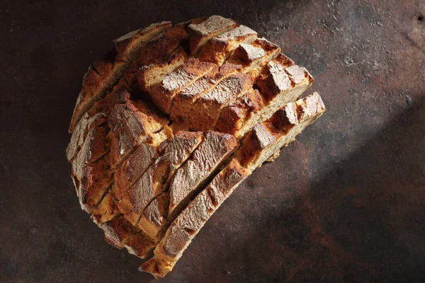 錆びた鉄の背景にスライスしたライ麦パン トップビュー — ストック写真