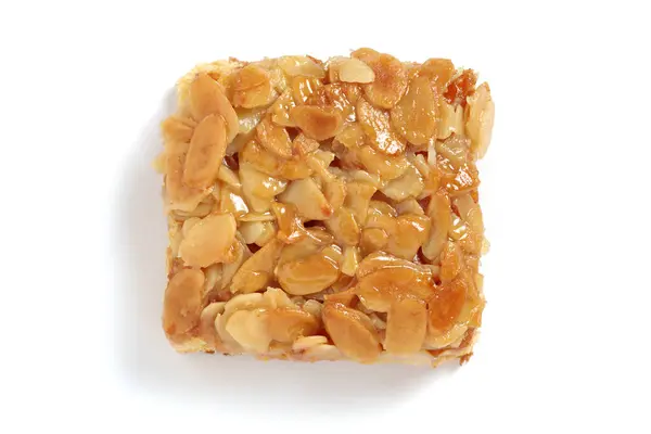 Homemade honey cake with almonds on a white background, top view