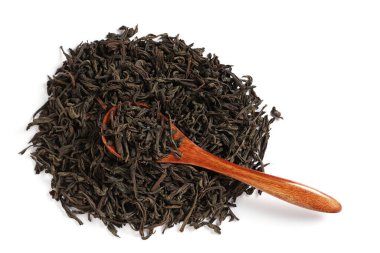 Bir yığın kurutulmuş siyah çay ve beyaz arka planda ahşap bir kaşık.