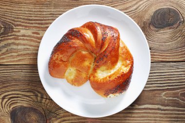 Ahşap bir tabakta taze tatlı çörek, üst manzara.