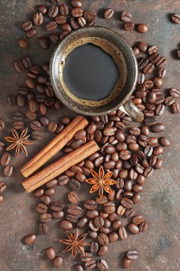 Paslı metal arka planda bir fincan kahve ve baharat.