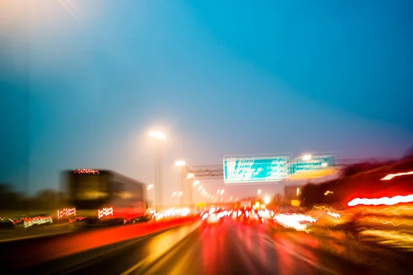 在繁忙的高速公路上 在高峰时间开车 抽象的运动模糊了 通过长期曝光摄影产生的光迹 免版税图库图片