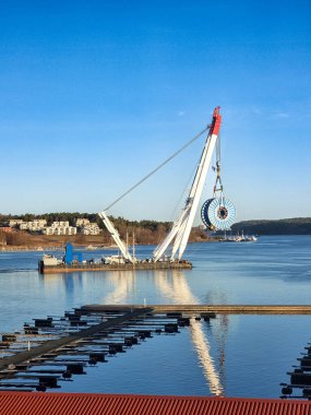 Heavy lift floating crane with cable reel off coast in fjord in southern Norway, beautiful quiet scenery under clear blue sky clipart