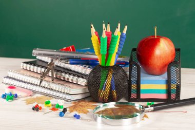 Okul malzemeleri hafif arka planda bir kompozisyonda sergilenir. Okula geri dön..