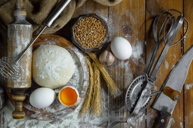 Eski bir arka planda un ve yumurtalarla hamur yoğurmak