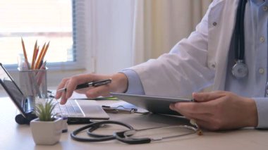 Genç doktor stajyer, bilgisayarda çalışıyor, veri tabanına veri girişi yapıyor. Eller yakın çekim. Yavaş çekim.