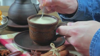 Espresso kahvesi içmeden önce bir erkeğin ellerinde kaşıkla karıştırılır. Yakın plan. Yavaş çekim.