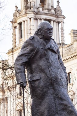Sir Winston Churchill bronze statue in Parliament Square Gardens created by Ivor Roberts-Jones. Close up image with white building in background. London, England - December 30, 2022.