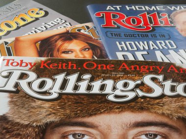 Close up of Rolling Stone paper print music magazine covers. Founded in San Francisco, California, 1967. Copenhagen, Denmark - May 7, 2023. clipart