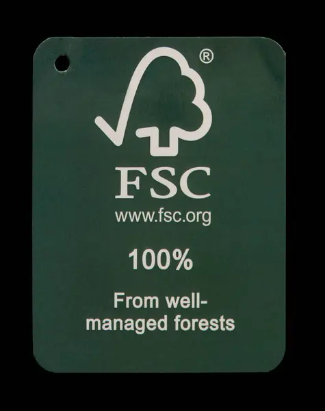 stock image FSC - Forest Stewardship Council - logotype on used green cardboard tag. 100 percent from well-managed forests. Close up photo isolated on black background. Copenhagen, Denmark - September 9, 2024.