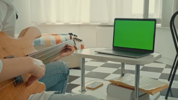 Женщина Смотрит Онлайн Класс Играет Гитаре Ноутбук Изолированным Зеленым Экраном — стоковое видео