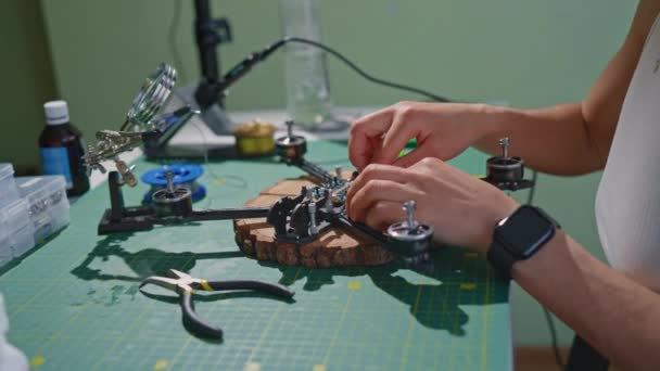 Una Persona Está Trabajando Meticulosamente Dron Sobre Una Mesa Usando — Vídeo de stock