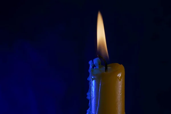 candle with smoke and flame photographed in the studio with color foils before the flashes