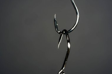 Fishing hook on a dark background. Close-up. Selective focus.