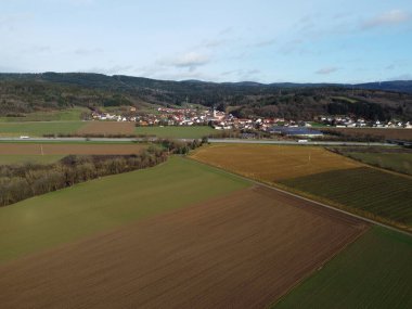 Aerial view of a small village in the middle of a field