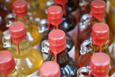 different colorful soap bottles on a white background