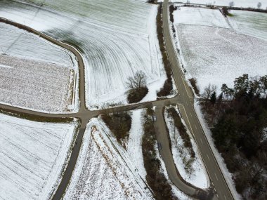 snow-covered agricultural fields in bavaria on a cloudy day