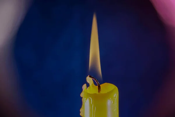 candle with smoke and flame photographed in the studio with color foils before the flashes