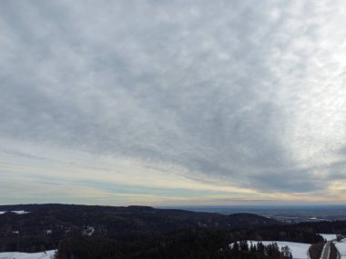 snowy agricultural snowy fields in bavaria on a cloudy day