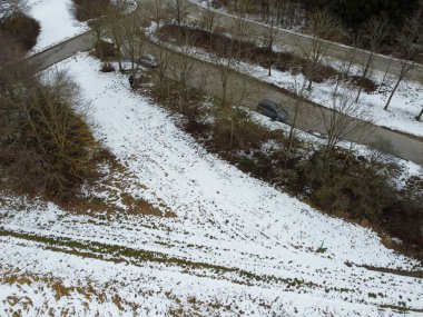 winter with agricultural fields covered with snow in bavaria on a cloudy day