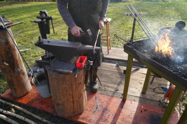 Demirci kızgın kömür ve demirle el işi yapıyor.