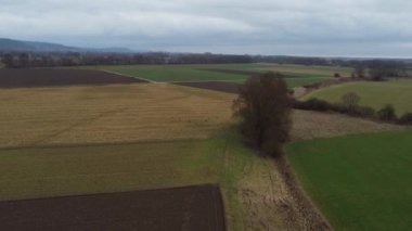 Fields and meadows with rain clouds in winter