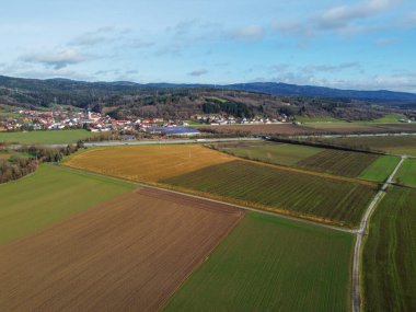 Aerial view of a small village in the middle of a field