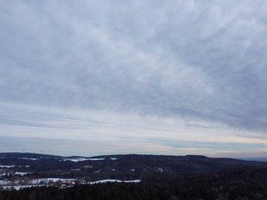 snow-covered agricultural fields in bavaria on a cloudy day