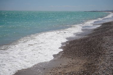 Akdeniz 'de çakıl taşı plajı ve yeşil suyu olan dalgalar