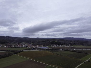 Aerial view of a small village in the middle of a field