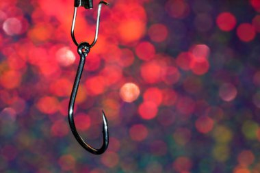 Fishing hook on a background of blue and white bokeh