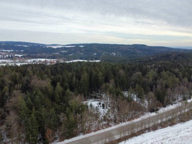 winter with agricultural fields covered with snow in bavaria on a cloudy day