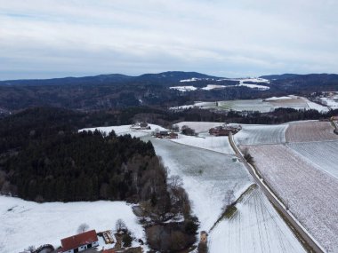 winter with agricultural fields covered with snow in bavaria on a cloudy day