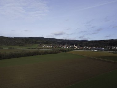 Aerial view of a small village in the middle of a field