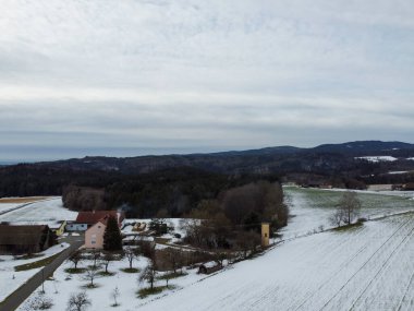 snowy agricultural snowy fields in bavaria on a cloudy day