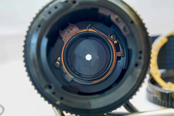 Camera lens with light and lens flare, close-up. Selective focus