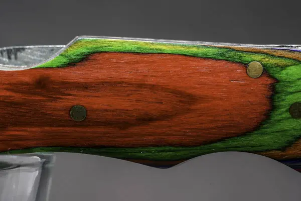 Pocket knife with wooden handle and forged scabbard in detail