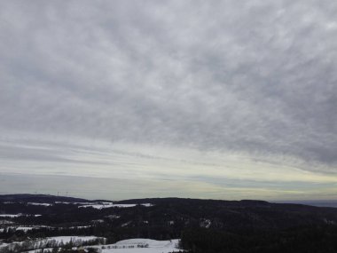 snowy agricultural snowy fields in bavaria on a cloudy day