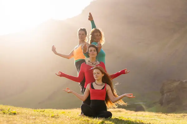 A group of girls meditate at sunset in Iceland