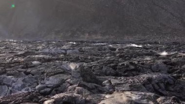 Hâlâ aktif olan bir volkanın ve İzlanda 'daki katı lav manzarasının görüntüsü.