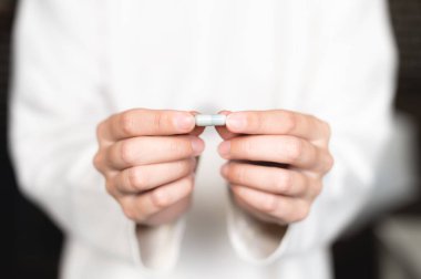 Womans hand with a white medical pill close-up. Health care, medical supplements concept.
