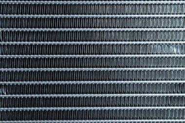 The texture of the car radiator. Engine cooler background. Vintage style. Car interior heater air conditioning radiator grille, close-up.