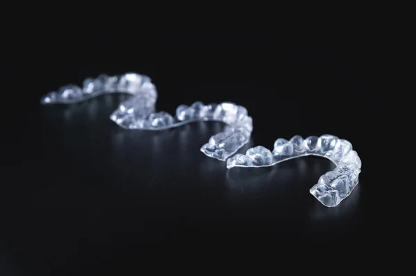 Three Invisible Plastic Aligners Lie Next Each Other Black Background — Stock Photo, Image