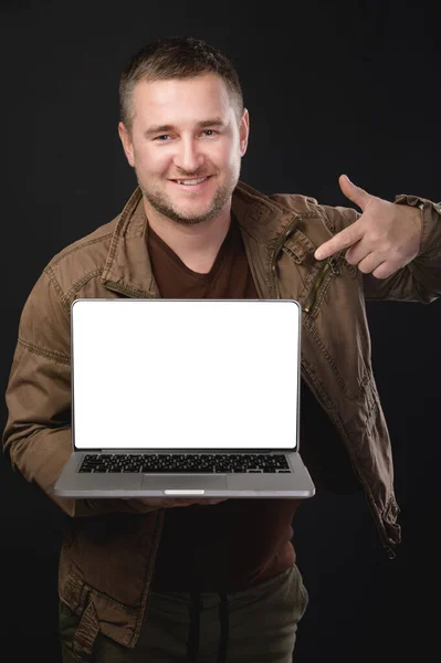 Handsome Smiling Bearded Man Holding His Laptop Pointing His Index — Stock Photo, Image