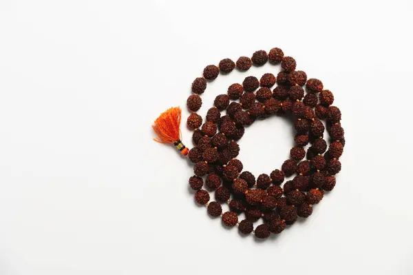 Stock image Wooden church rosary made of dark wood on a white background. Church rosary for prayer close-up.