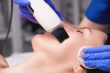 Güzellik salonu. Cihaz, yüzü ultrasonla temizliyor, yakın plan. Profesyonel kozmetoloji ve güzellik konsepti.