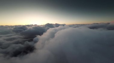 Uçak penceresi manzarası, bulutların üstünde yüksek irtifa uçuşu günbatımında, ufuk..